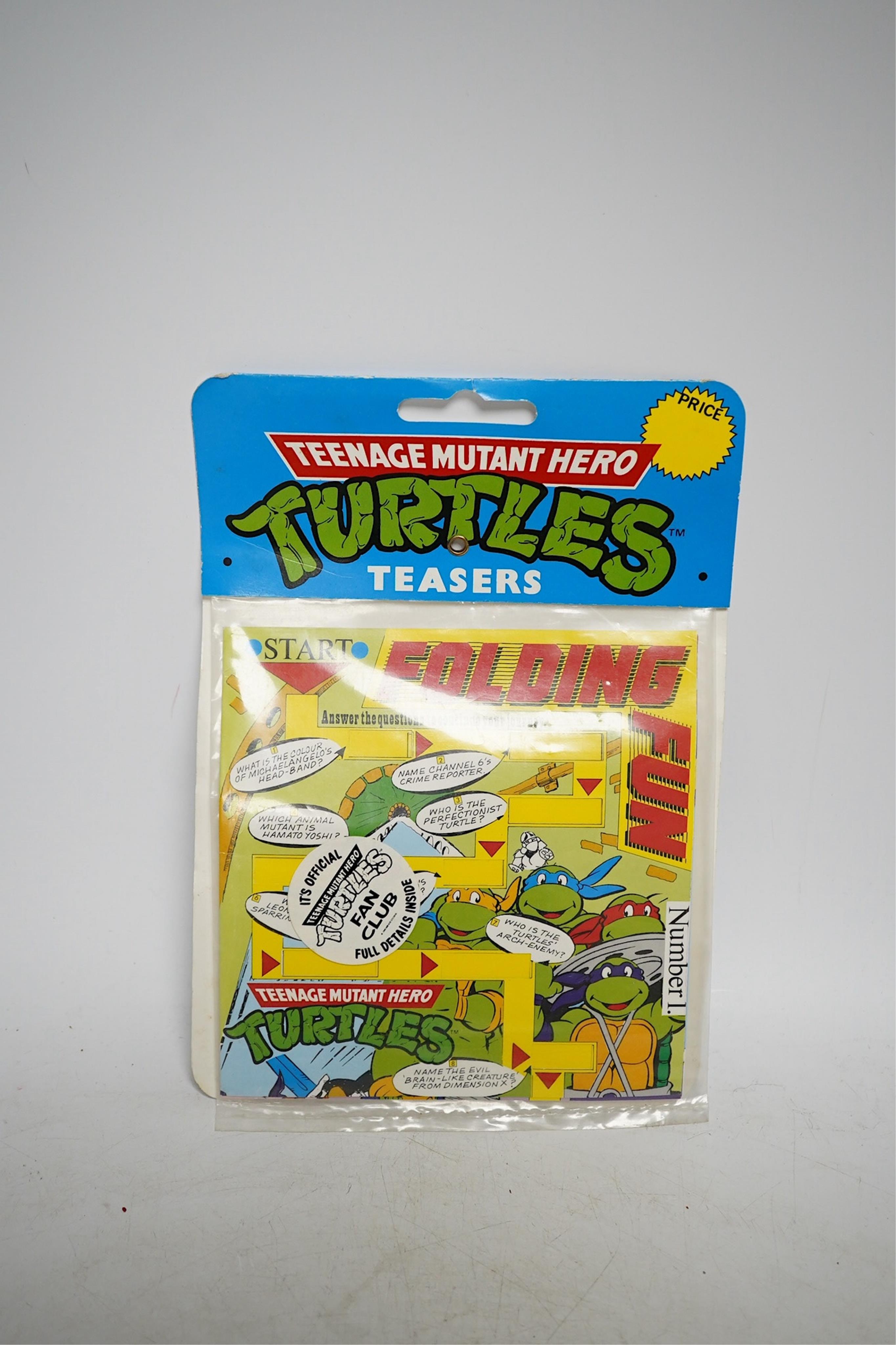 A Playmates Teenage Mutant Ninja Turtles figure of Michaelangelo, dated 1988, a Teenage Mutant Hero Turtles packeted ‘Teasers’, dated 1990, and a Matchbox Ring Raiders toy. Condition - fair to good, some creases to backi